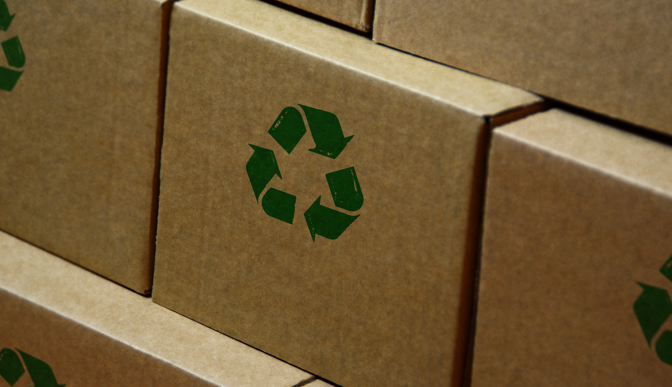 Recycling stamp printed on cardboard box. Recycle symbol, arrows, recyclable materials, environmental protection and earth safe concept.